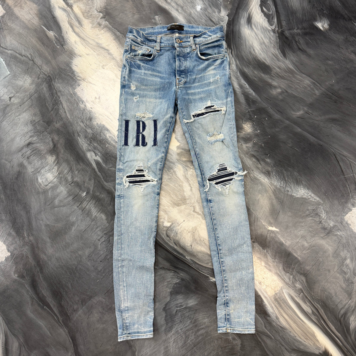Amiri Distressed Repaired Denim Jeans with Logo