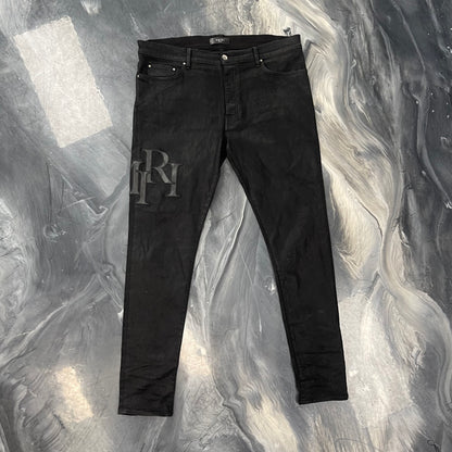 Amiri Staggered Logo Waxed Skinny Jeans