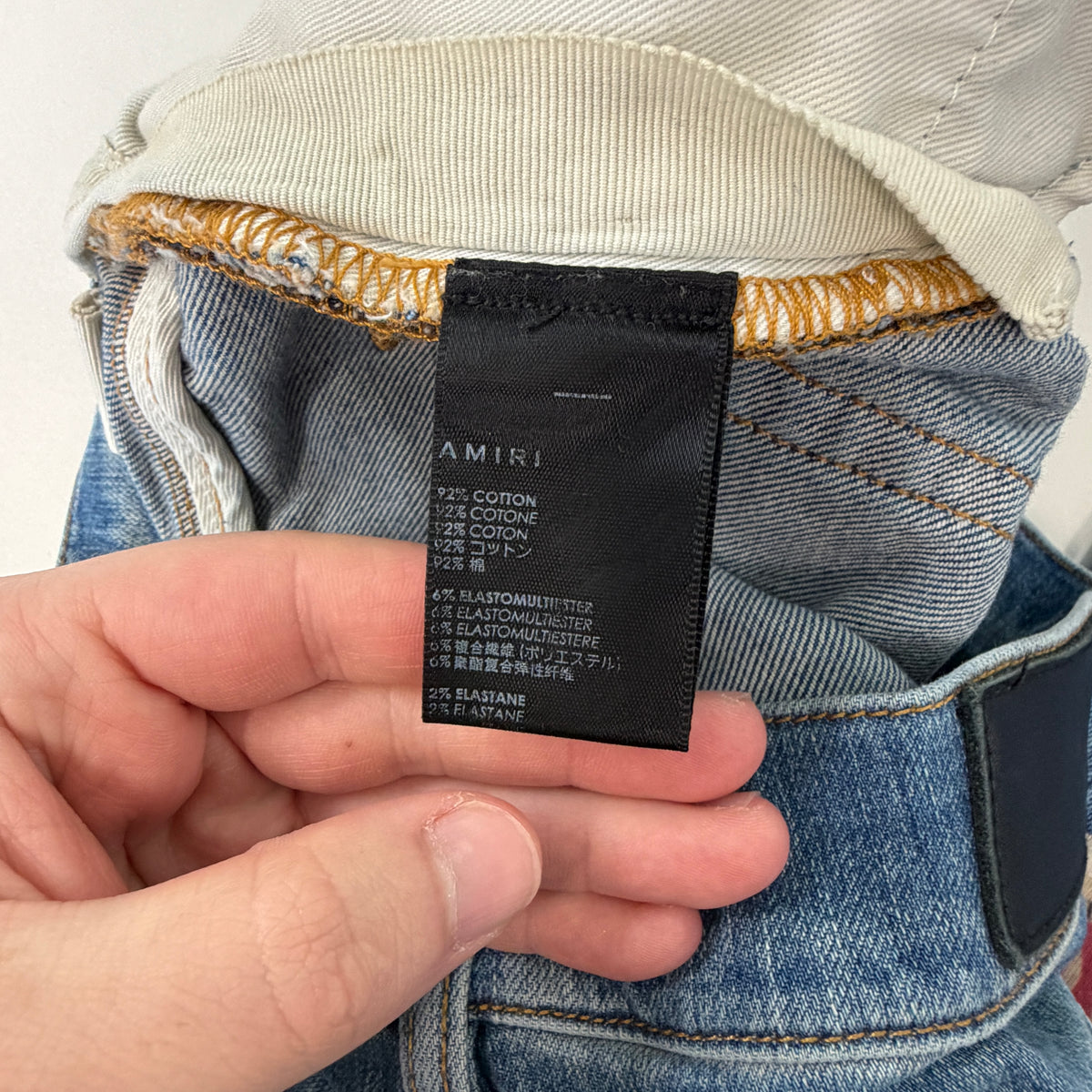 Amiri Distressed Repaired Denim Jeans with Logo