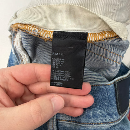 Amiri Distressed Repaired Denim Jeans with Logo