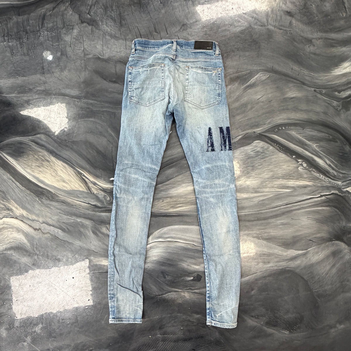 Amiri Distressed Repaired Denim Jeans with Logo