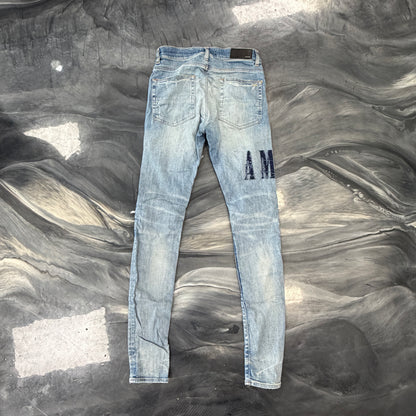 Amiri Distressed Repaired Denim Jeans with Logo